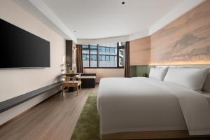 Voodi või voodid majutusasutuse JINGCADIA Hotel Nanjing Confucius Temple toas