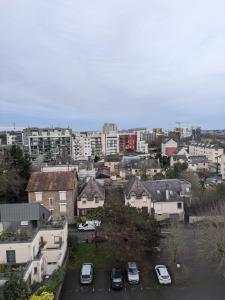 a city with cars parked in a parking lot at La promenade in Rennes
