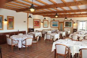 a dining room with white tables and chairs at Quinta dos Poetas Nature Hotel & Apartments in Olhão