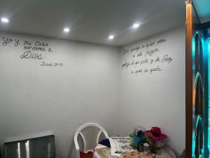 una habitación con una mesa y una pared con escritura. en INGEMEND, en San Gabriel