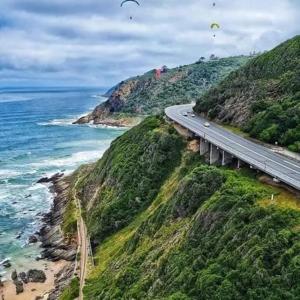 a highway on top of a mountain next to the ocean at 84 Milkwood Drive with Solar Energy in Knysna