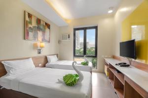Postel nebo postele na pokoji v ubytování ABC Hotel CEBU