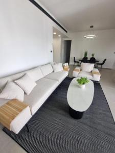 a living room with a couch and a table at chic boutique penthouse walk to the beach ashdod in Ashdod
