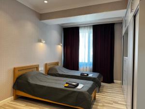 Postel nebo postele na pokoji v ubytování Premium Khatai Residence Boulevard, Victory Park