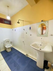 a bathroom with a sink and a toilet at Relax mountain guest house in Badulla