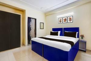Postel nebo postele na pokoji v ubytování Super Hotel O Sheetla Colony
