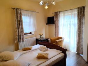 a bedroom with two beds in front of a window at Vila Iulia in Vatra Dornei