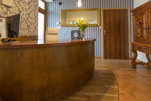 a reception desk with a vase of flowers on it at Willa Labelle in Zakopane