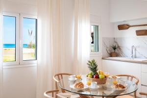 a kitchen with a glass table with fruit on it at Coastal Key 6 in Gázion