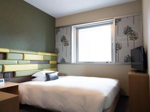 Postel nebo postele na pokoji v ubytování Hearton Hotel Kita Umeda