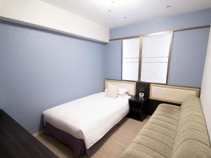 Postel nebo postele na pokoji v ubytování Hearton Hotel Kita Umeda