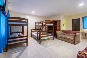a room with three bunk beds and a couch at Panglao villa family reunions in Panglao +110 photos