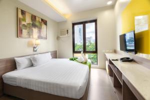 Postel nebo postele na pokoji v ubytování ABC Hotel CEBU