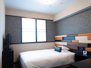 Postel nebo postele na pokoji v ubytování Hearton Hotel Kita Umeda