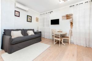 a living room with a couch and a table at Casa Matteotti in Rovinj