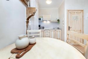 a kitchen with a table with two vases on it at Casa Matteotti in Rovinj