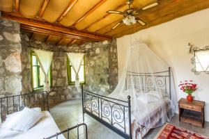 a bedroom with two beds and a ceiling at Otantik Tas Ev in Dalaman +102 photos