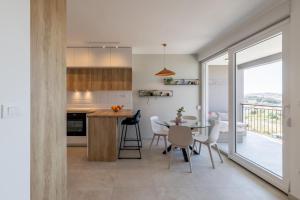a kitchen and dining room with a table and chairs at Apartment Solin Mezanovci in Klis