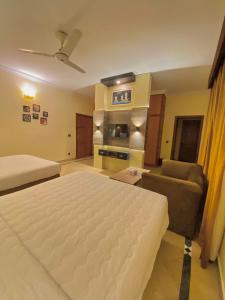 Ένα ή περισσότερα κρεβάτια σε δωμάτιο στο Orbit Residency Jinnah Super