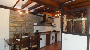 a kitchen with a table and a stove top oven at Apartamentos Legado de Santillana in Santillana del Mar