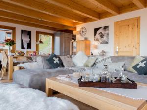 a living room with a couch and a coffee table at Chalet Petit Sapin in La Tzoumaz