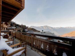 a balcony with benches and a view of a mountain at Chalet Petit Sapin in La Tzoumaz +27 photos