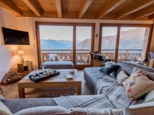 a living room with a couch and a table at Chalet Petit Sapin in La Tzoumaz +27 photos