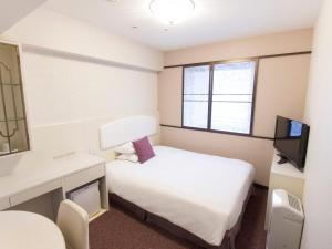 Postel nebo postele na pokoji v ubytování Hearton Hotel Kita Umeda