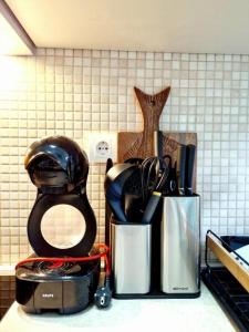 a kitchen counter with utensils in a container at Apartman BJANKA in Budva +23 photos