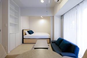 a bedroom with a bed and a couch and a table at Reve Asakusa in Tokyo +79 photos