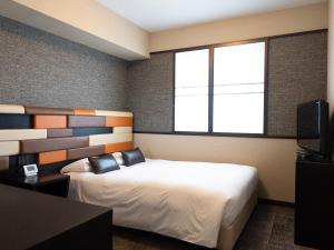Postel nebo postele na pokoji v ubytování Hearton Hotel Kita Umeda