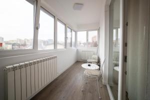 a bathroom with a toilet and a sink and windows at Urban Luxury Studios by Cozy Apartments in Iaşi
