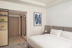 Postel nebo postele na pokoji v ubytování Towers Rotana - Dubai