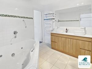 a white bathroom with a tub and a sink at Town & Tide, Cowes Central in Cowes +25 photos