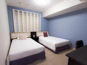 Postel nebo postele na pokoji v ubytování Hearton Hotel Kita Umeda