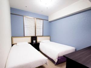 Postel nebo postele na pokoji v ubytování Hearton Hotel Kita Umeda