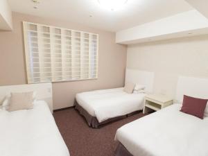 Postel nebo postele na pokoji v ubytování Hearton Hotel Kita Umeda