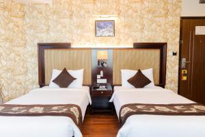 Rúm í herbergi á Hotel Mirage Regency