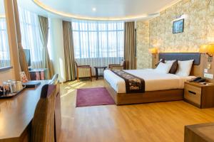 Rúm í herbergi á Hotel Mirage Regency