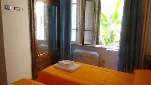 羅馬的住宿－Bed and Breakfast Adduci's House，一间卧室配有橙色的床和窗户。