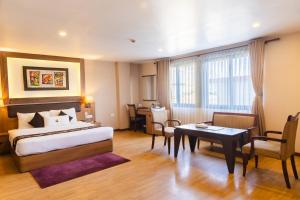 Rúm í herbergi á Hotel Mirage Regency
