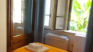 a room with a table and a window and towels at Bed and Breakfast Adduci's House in Rome