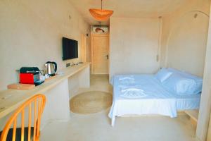 a small bedroom with a bed and a desk at Felix Rooms in Marmaris