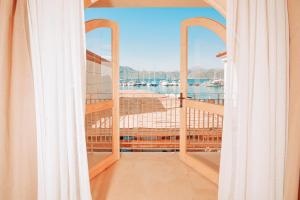 a room with a balcony with a view of the water at Felix Rooms in Marmaris