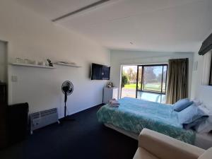 a hotel room with a bed and a window at Shambala in Te Kauwhata