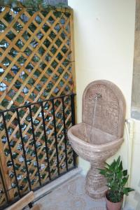 a bathroom with a toilet in a room at Casa tua a due passi da Ortigia! in Syracuse