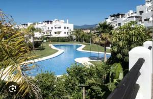 a view of a swimming pool in a resort at Luxury apartment Sunset Golf with spacious private garden & seaview in Estepona