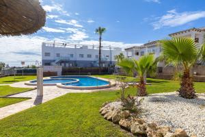 a resort with a swimming pool and palm trees at Azalea - Stylish Apartment with Rooftop & Pool in Los Altos +32 photos