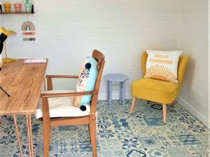 a room with a table and two chairs and a table and a pillow at Southern Bell in South Hayling +14 photos