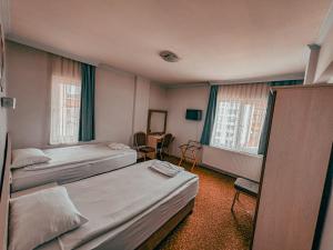 a hotel room with two beds and two windows at Oreko Express in Afyon